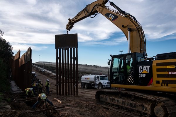 A construction crew works on replacing the U.S.-Mexico border fence as seen from Tijuana