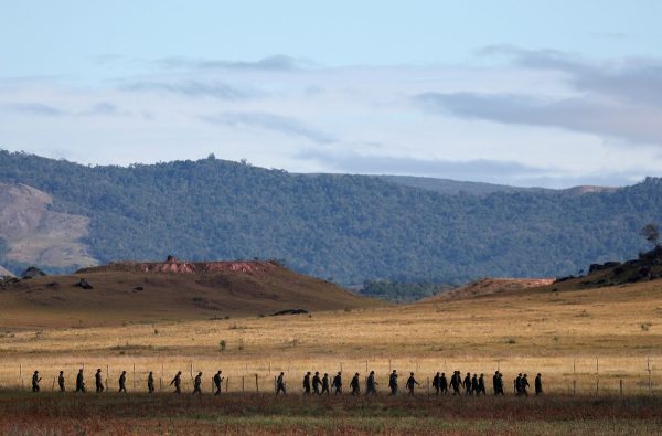 Venezuelan soldiers walk at the border 