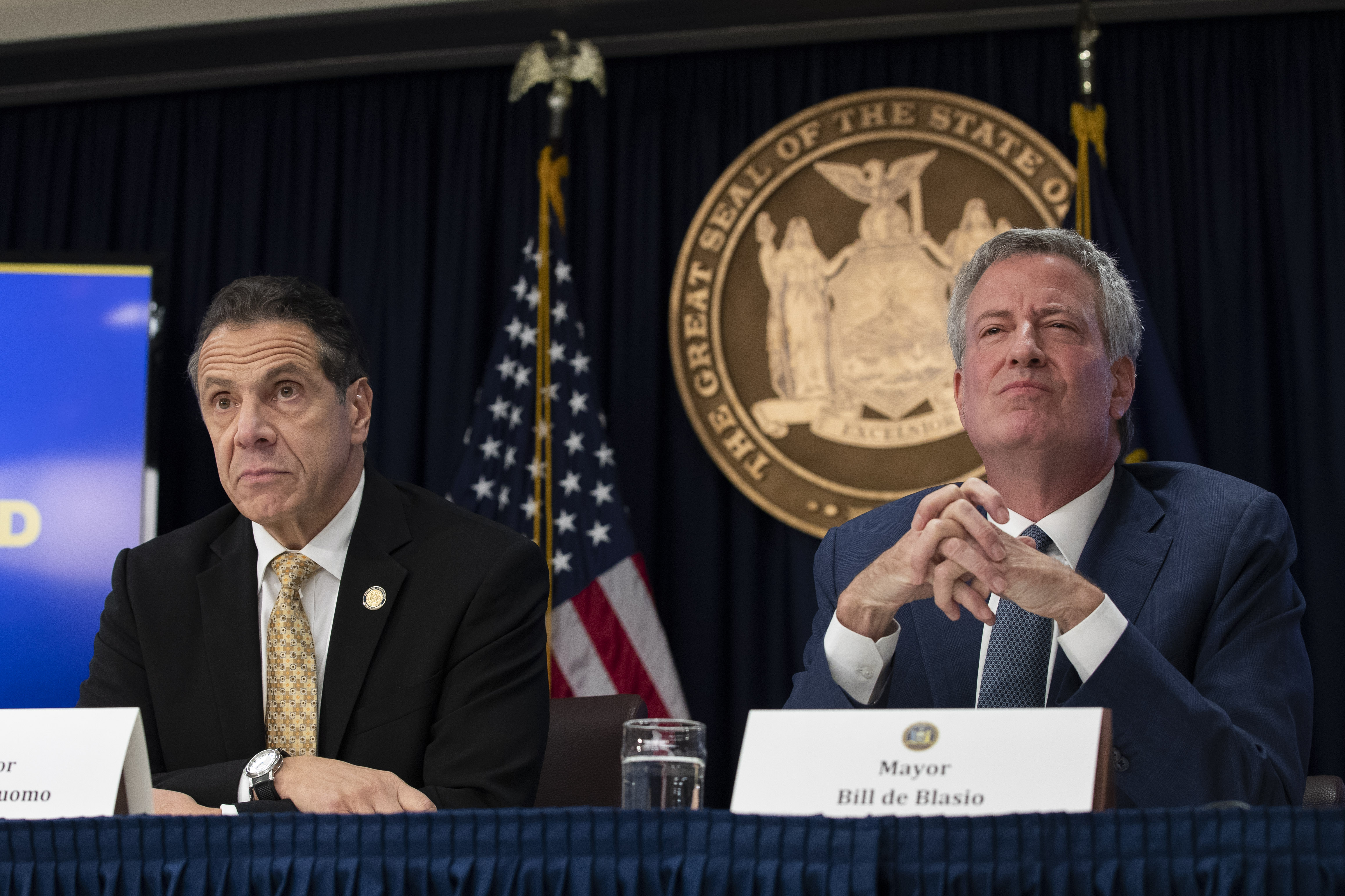 New York Governor Andrew Cuomo (L) and New York City Mayor Bill de Blasio listens to questions from reporters during a press conference to discuss Amazon's decision to bring a new corporate location to New York City in New York City