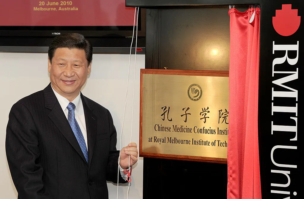 China's then-Vice President Xi Jinping (now Chinese leader) unveils a plaque at the opening of Australia's first Chinese Medicine Confucius Institute at the RMIT University in Melbourne on June 20, 2010.  (William West/AFP/Getty Images)