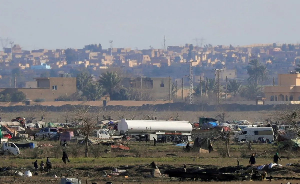ISIS members walk in the last besieged neighborhood in the village of Baghouz, Deir Al Zor province in Syria, on Feb. 18, 2019. (Rodi Said/Reuters)