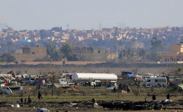 Islamic state members walk in the last besieged neighborhood