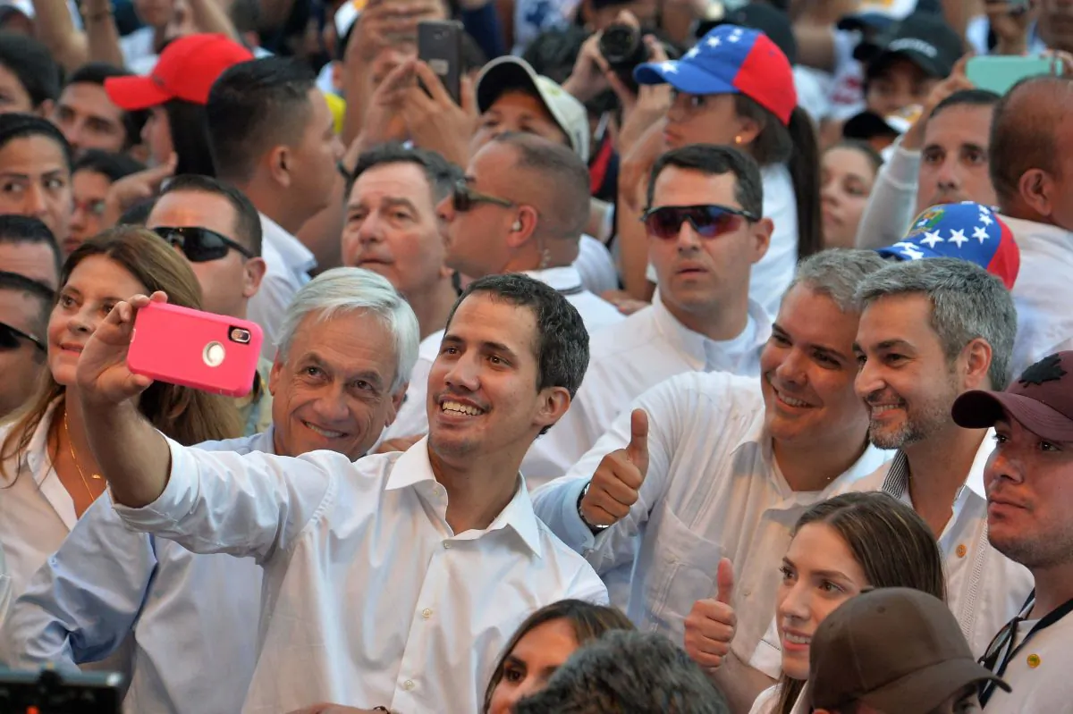 Venezuela's opposition leader Juan Guaido (C) takes a selfie his wife Fabiana Rosales (R, foreground), Chilean President Sebastian Pinera (next to him at left), Colombian President Ivan Duque (2-R, giving thumb up), and Paraguayan President Mario Abdo Benitez (R) during the "Venezuela Aid Live" concert in Cucuta, Colombia, on Feb. 22, 2019. (Luis Robayo/AFP/Getty Images)