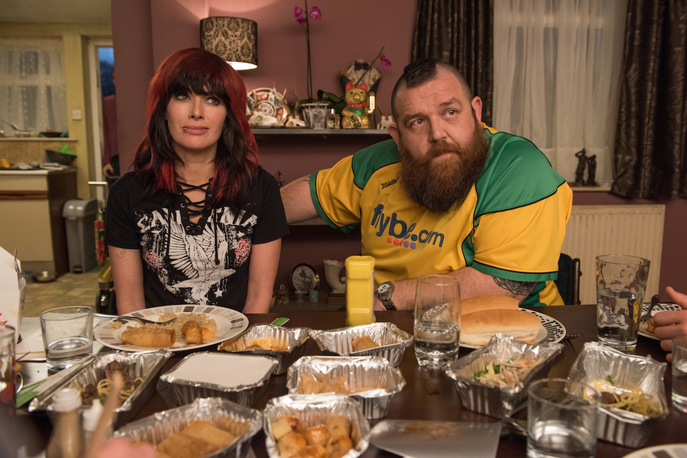 man and wife wrestlers sit at dinner table