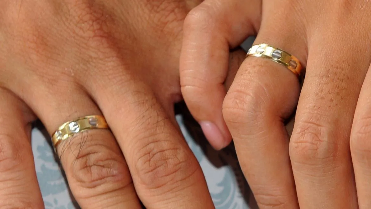 A couple holds hands in an undated file photo. (Jay Directo/AFP/Getty Images)
