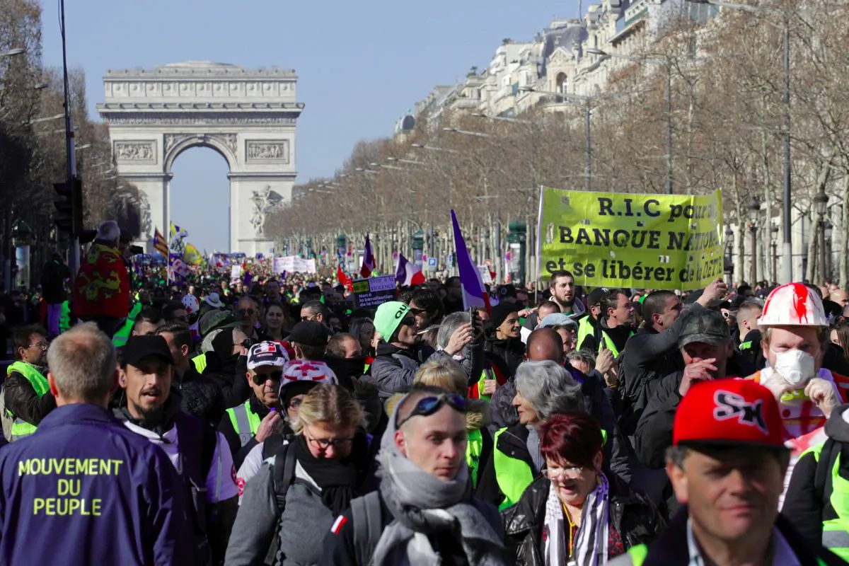 Protesters wearing yellow vests march down the Champs Elysees in Paris on Feb. 23, 2019. (Philippe Wojazer/Reuters)