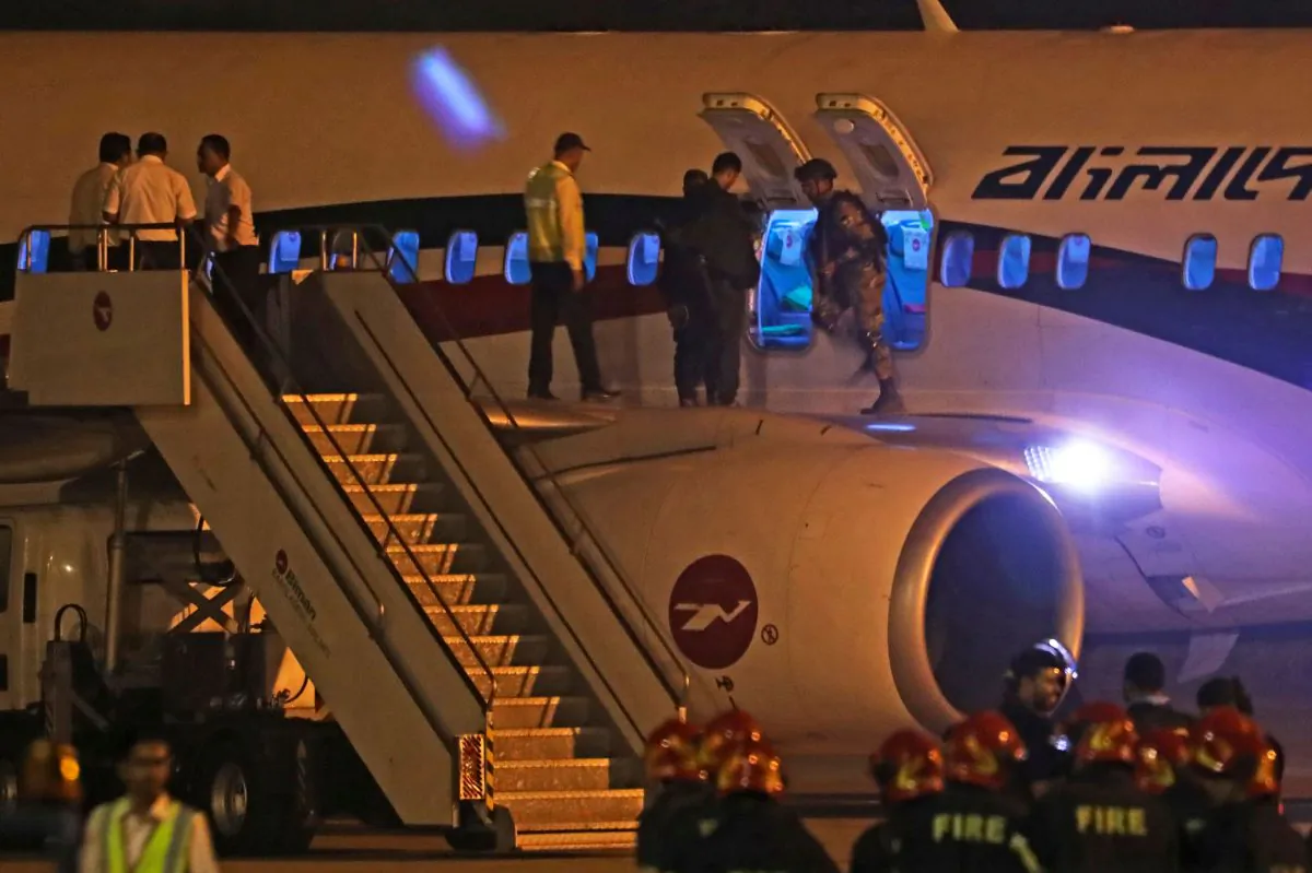 Bangladeshi security personnel near a Dubai-bound Bangladesh Biman plane on the tarmac of the Shah Amanat International Airport in Chittagong on Feb. 24, 2019. (STR/AFP/Getty Images)
