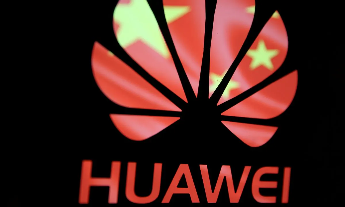 A Huawei logo in front of the Chinese Communist Party flag. National security experts warn of the security risks associated with Huawei in a panel event on March 21, 2019. (Dado Ruvic/Reuters)