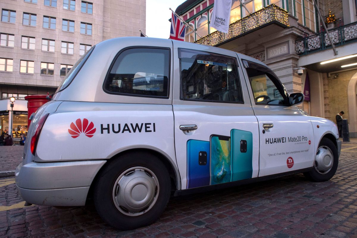 A London taxi carrying advertising for Chinese technology giant Huawei