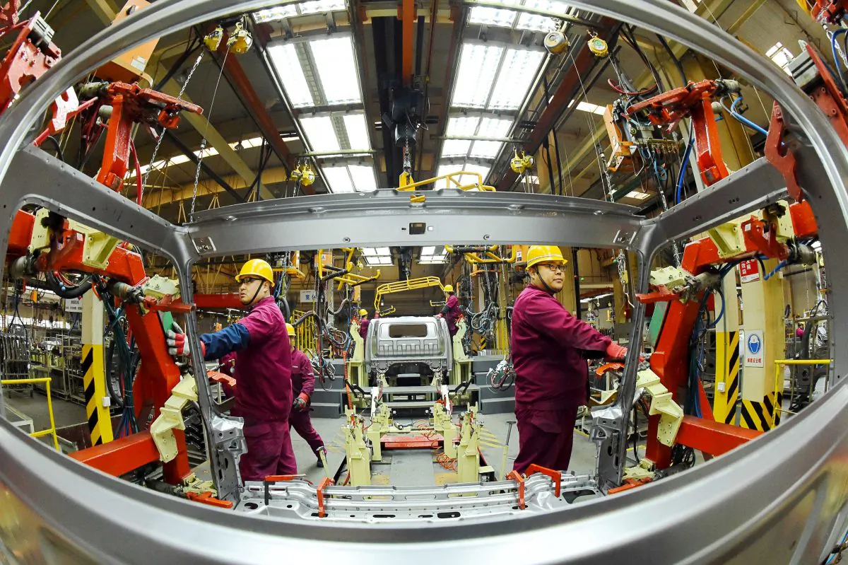 Employees work on a production line manufacturing light trucks at a JAC Motors plant in Weifang, Shandong Province, China on Nov. 30, 2018. (Reuters)