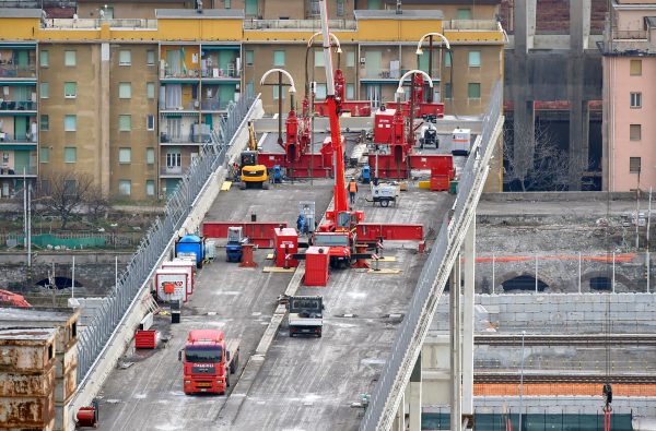 Construction workers dismantle the collapsed Morandi Bridge in Genoa, Italy