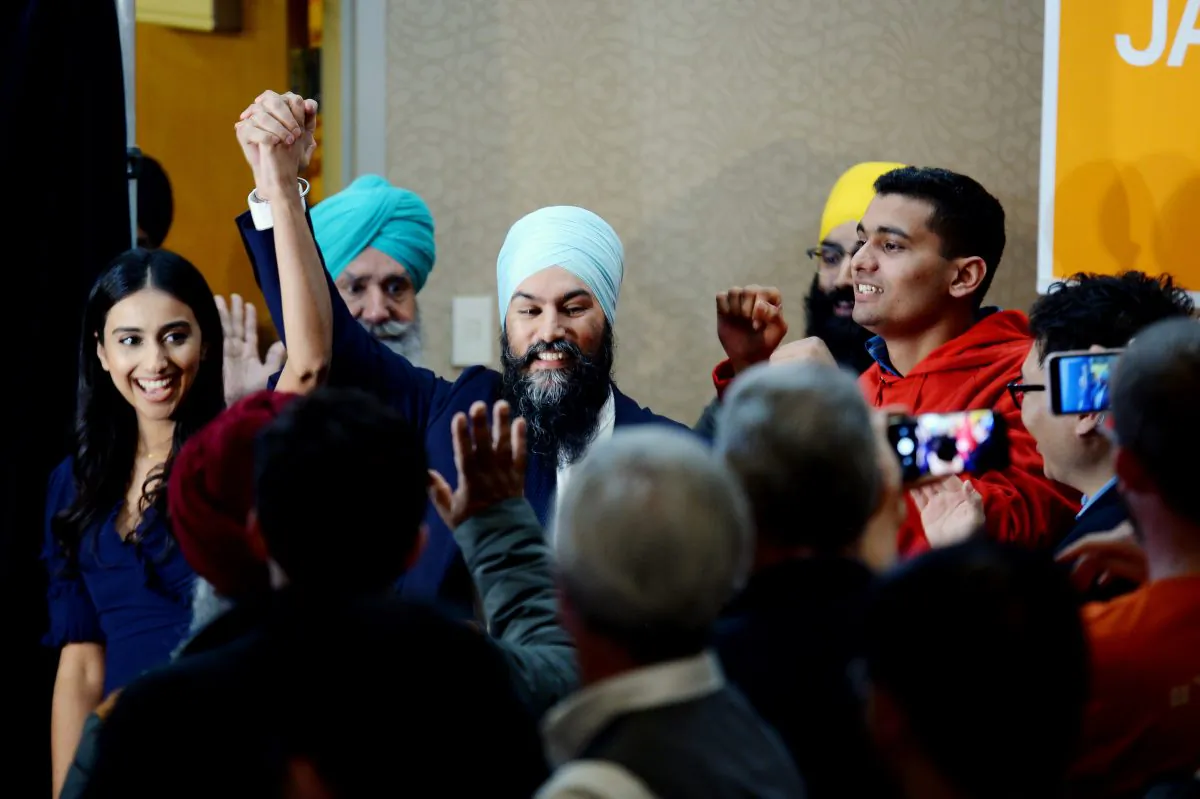 NDP leader Jagmeet Singh celebrates his Burnaby South byelection win with his wife Gurkiran Kaur Sidhu as they arrive at his election night party in Burnaby, B.C., Monday, Feb. 25, 2019. (The Canadian Press/Jonathan Hayward)