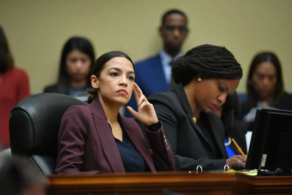 Rep. Alexandria Ocasio-Cortez (D-N.Y.) listens as Michael Cohen, former attorney for President Donald Trump, testifies before the House Oversight and Reform Committee in the Rayburn House Office Building on Capitol Hill on Feb. 27, 2019. (MANDEL NGAN/AFP/Getty Images)