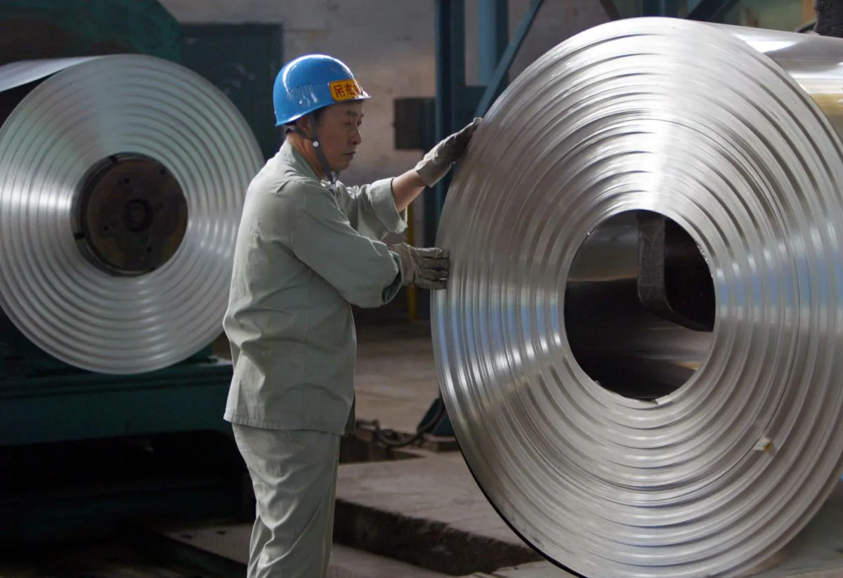 A laborer works at a cold-rolling mill of the Wuhan Iron & Steel Group on the outskirts of Wuhan, capital of central China's Hubei Province on Aug. 22, 2006. (Alfred Cheng Jin/Reuters)