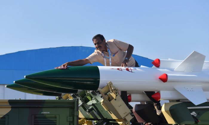 A staff cleans Akash, a medium-range mobile surface-to-air missile defense system developed by the Defence Research and Development Organisation (DRDO), on the second day of the 5-day, of Aero India airshow at the Yelahanka Air Force Station in Bangalore on Feb. 21, 2019. (Manjunath Kiran/AFP/Getty Images)