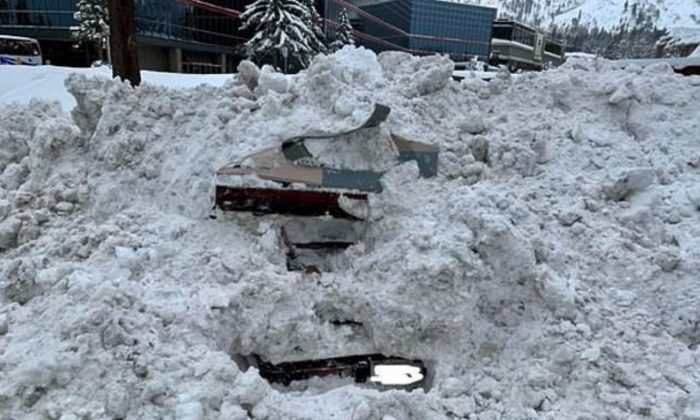 A snowplow struck a car that was completely buried by snow in South Lake Tahoe, California, on Feb. 17, 2019. Unbeknownst to crews, there was a woman inside. (City of South Lake Tahoe)