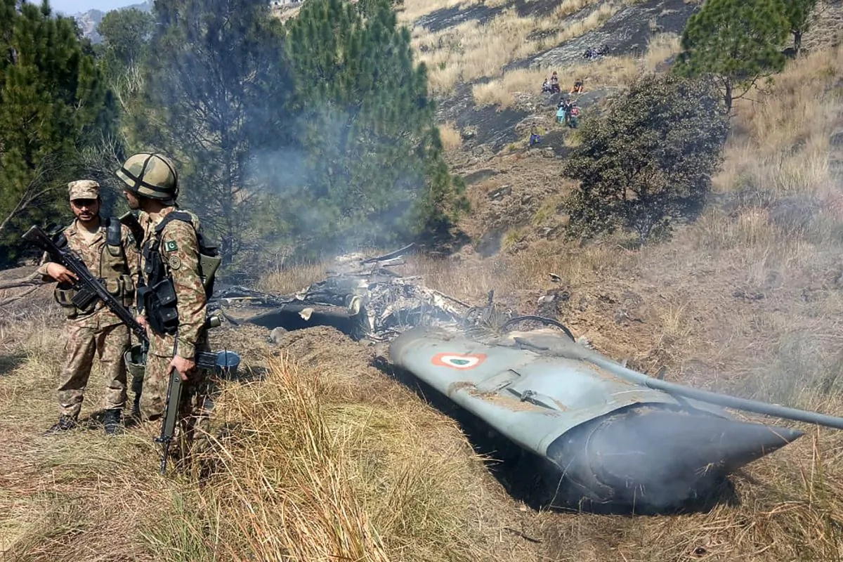 Pakistani soldiers stand next to what Pakistan says is the wreckage of an Indian fighter jet shot down in Pakistan controled Kashmir at Somani area in Bhimbar district near the Line of Control on Feb. 27, 2019. (STR/AFP/Getty Images)