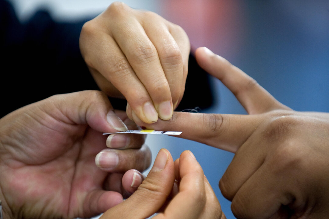 File photo showing a nurse taking a blood sample to establish the level of cholesterol of a visitor during the World Summit against Obesity, in Mexico City, on Aug. 20, 2009. (Luis Acosta/AFP/Getty Images)