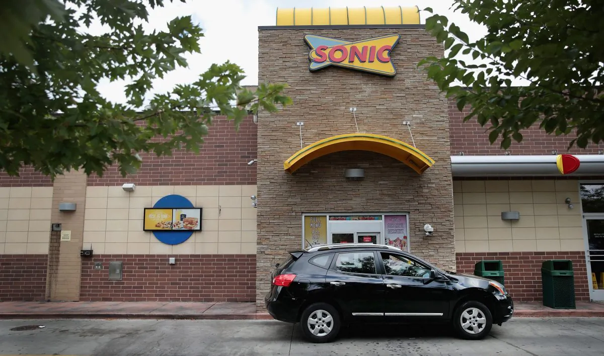 A customer picks up food at the drive-up window at a Sonic restaurant on September 25, 2018  (Photo by Scott Olson/Getty Images)