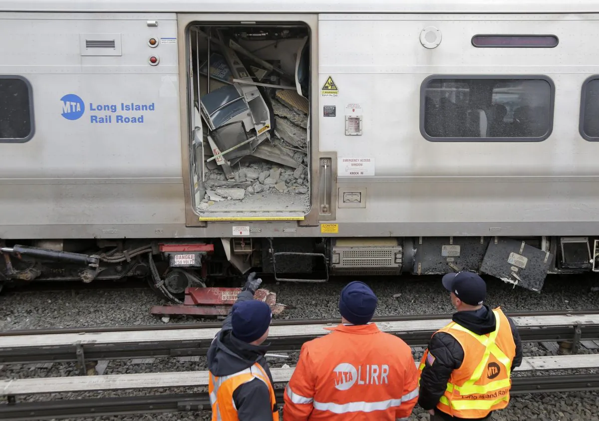 Emergency personnel look over a train that derailed after striking a vehicle in Westbury, N.Y., on Feb. 27, 2019. (Seth Wenig/AP Photo)