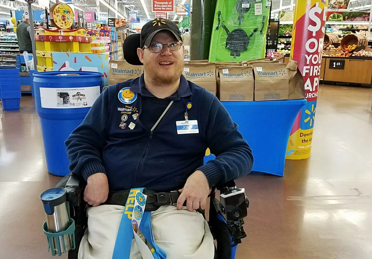 Walmart greeter John Combs works at a Walmart store in Vancouver, Wash., on April 21, 2018. (Rachel Wasser via AP)