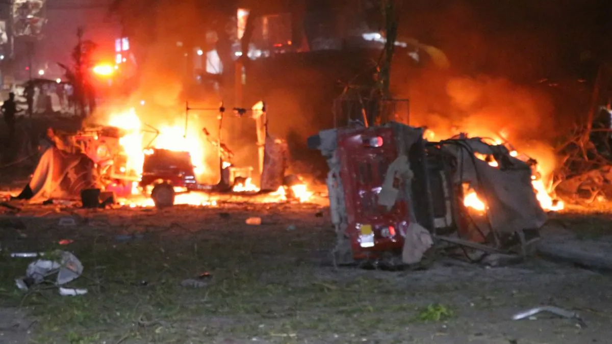 Shells of vehicles burn outside the Maka Al-Mukarama hotel in the Somalia capital, Mogadishu, on Feb. 28, 2019, after a car bomb exploded, killing at least five people and wounding 25 others. (Abdirazak Hussein Farah/AFP/Getty Images)