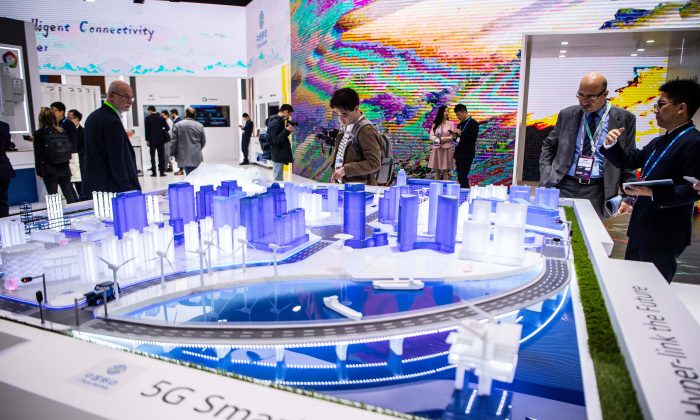 Visitors check a 5G Smart City technology at the China Mobile booth at the GSMA Mobile World Congress 2019 in Barcelona, Spain on Feb 26, 2019. The annual Mobile World Congress hosts some of the world's largest communications companies, with many unveiling their latest phones and wearables gadgets like foldable screens and the introduction of the 5G wireless networks. (David Ramos/Getty Images)