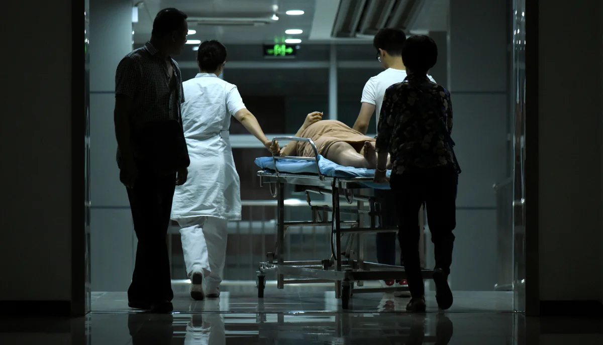 A pregnant woman on a stretcher in a hospital in Beijing, China. (Wang Zhao/AFP/Getty Images)