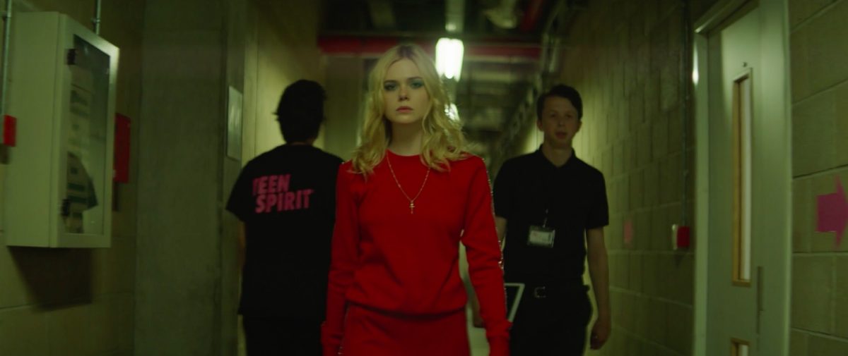 girl in red walks down hall