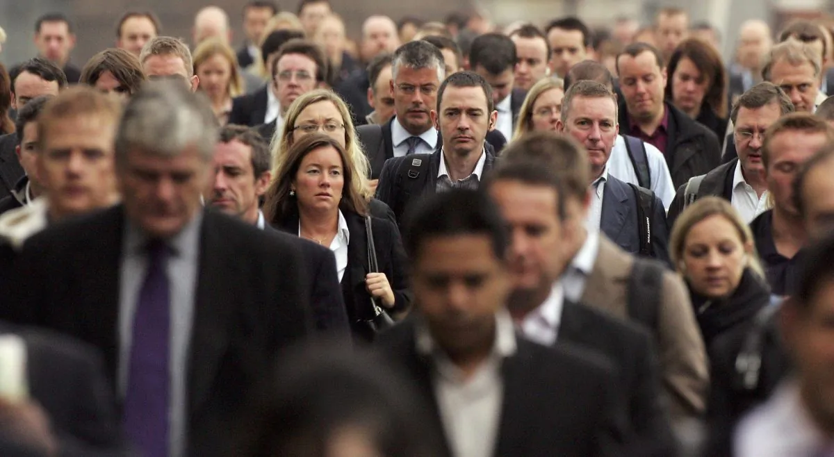 Commuters walk to work over London Bridge in London on Oct. 5, 2006. Scott Barbour/Getty Images
