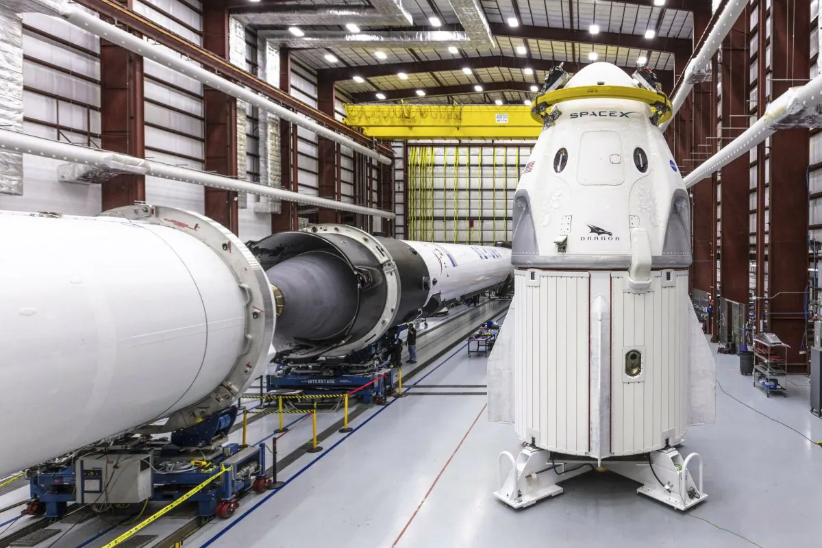 SpaceX's Crew Dragon spacecraft and Falcon 9 rocket are positioned inside the company's hangar at Launch Complex 39A at NASA's Kennedy Space Center in Florida, on Dec. 18, 2018. (Space X via AP)