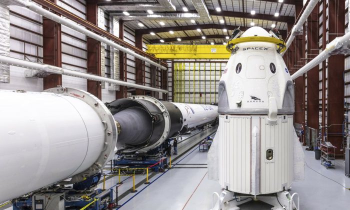 SpaceX's Crew Dragon spacecraft and Falcon 9 rocket are positioned inside the company's hangar at Launch Complex 39A at NASA's Kennedy Space Center in Florida, on Dec. 18, 2018. (Space X via AP)