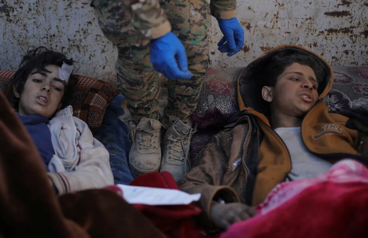 Hareth Najem, an Iraqi orphan lies under a blanket in a truck, near the village of Baghouz, Deir Al Zor province, Syria, on March 1, 2019. (Rodi Said/Reuters)