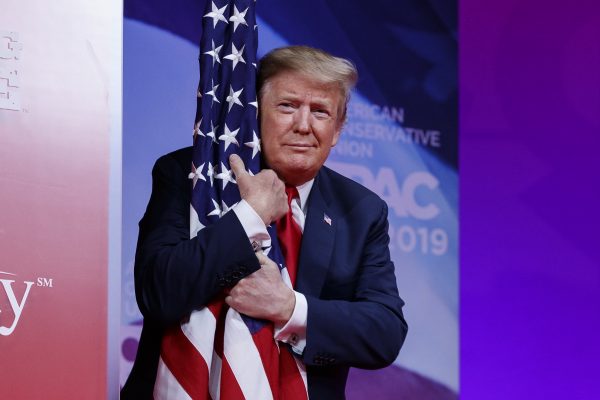 Donald Trump hugs flag at CPAC 2019