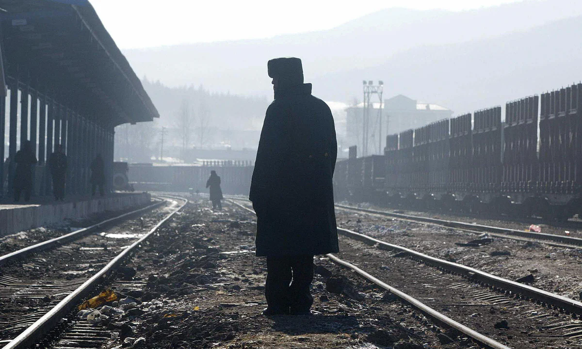 A Chinese paramilitary officer between railroad tracks. (FREDERIC J. BROWN/AFP/Getty Images)