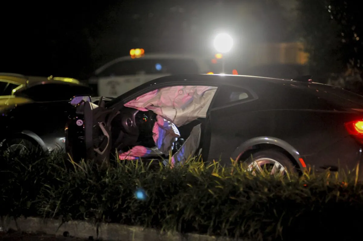 Police officers process a damaged vehicle after responding to a crash in a file photo. (Shawn Fink/The Advocate via AP)