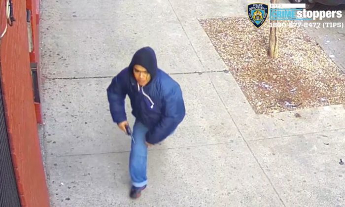 A gunman identified by the NYPD as 16-year-old Edgar Garcia opens fire on a crowded street in the Bronx borough of N.Y., on Feb. 22, 2019. (New York City Police Department via AP)