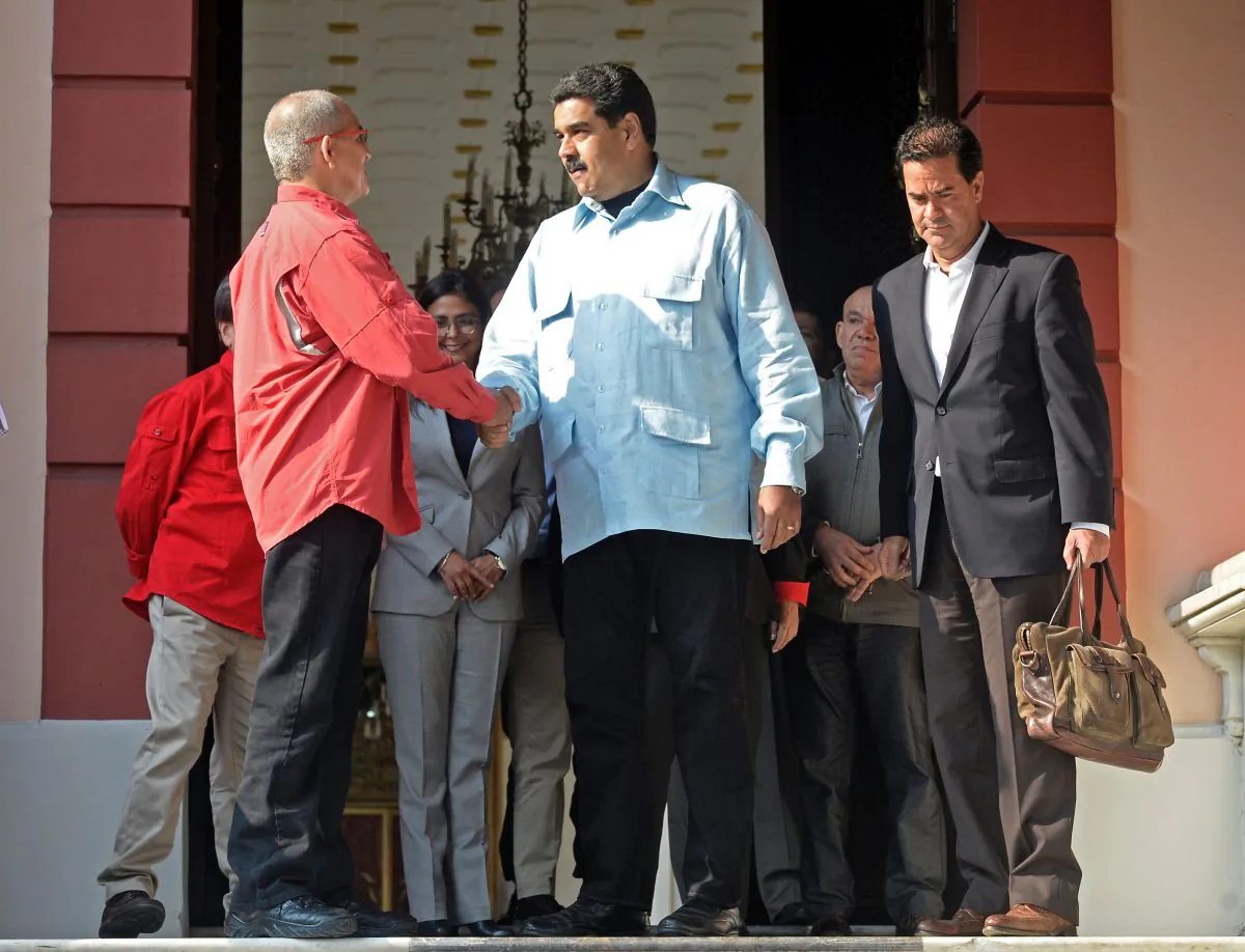 Venezuelan regime leader Nicolas Maduro (C) shakes hands with Eliecer Herlinton Chamorro Acosta, a leader of the leftist guerrilla group ELN, at the end of a meeting with a negotiator of the Colombian government, Frank Pearl (R), in Caracas, Venezuela, on March 30, 2016. (Federico Parra/AFP/Getty Images)
