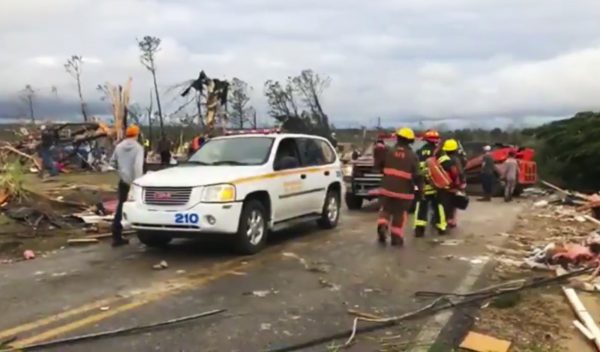 Emergency responders work in the scene amid debris in Lee County