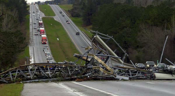 A fallen cell tower lies across U.S. Route 280 highway in Lee County
