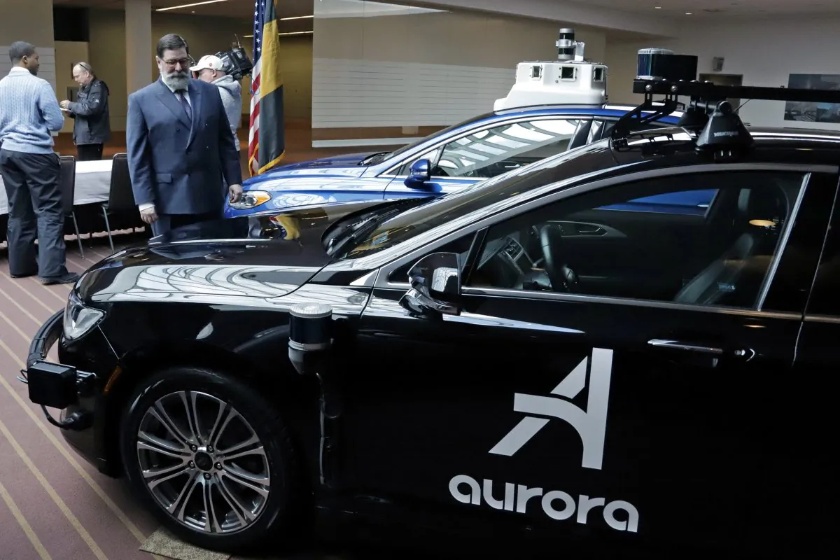 Pittsburgh Mayor William Peduto, left, checks out autonomous vehicles designed by Aurora Innovations in Pittsburgh, Mar. 4, 2019. (Gene J. Puskar/AP)