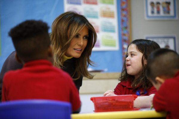 First lady Melania Trump leans in to listen to a student