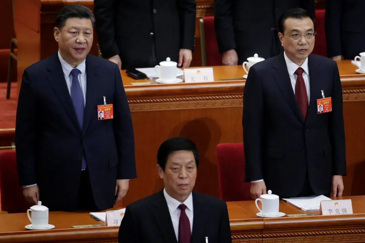 Chinese leader Xi Jinping (L), Chinese Premier Li Keqiang (R), and Li Zhanshu, head of China’s rubber-stamp legislature, at the Great Hall of the People in Beijing on March 5, 2019. (Jason Lee/Reuters)