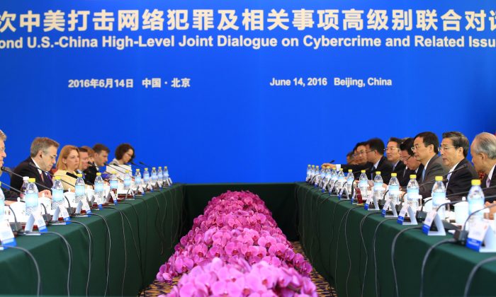 China's Minister of Public Security Guo Shengkun (3rd R) and U.S. Ambassador to China Max Baucus (2nd L) attend the second U.S.-China High-Level Joint Dialogue on Cybercrime and Related Issues at the Diaoyutai State Guesthouse in Beijing on June 14, 2016. (Jason Lee/AFP/Getty Images)