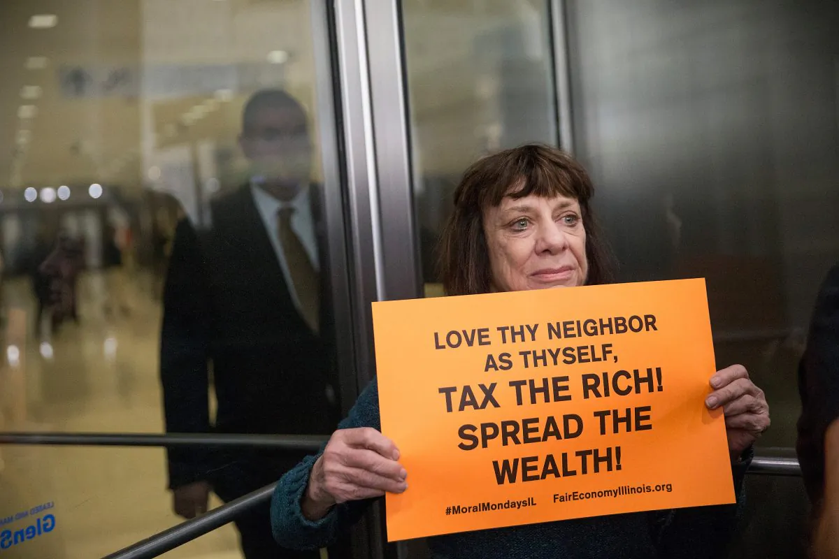 A demonstrator, protesting the state of Illinois budget stalemate, blocks an entrance to the Chicago Board of Trade building on Nov. 2, 2015 in Chicago, Illinois. Scott Olson/Getty Images