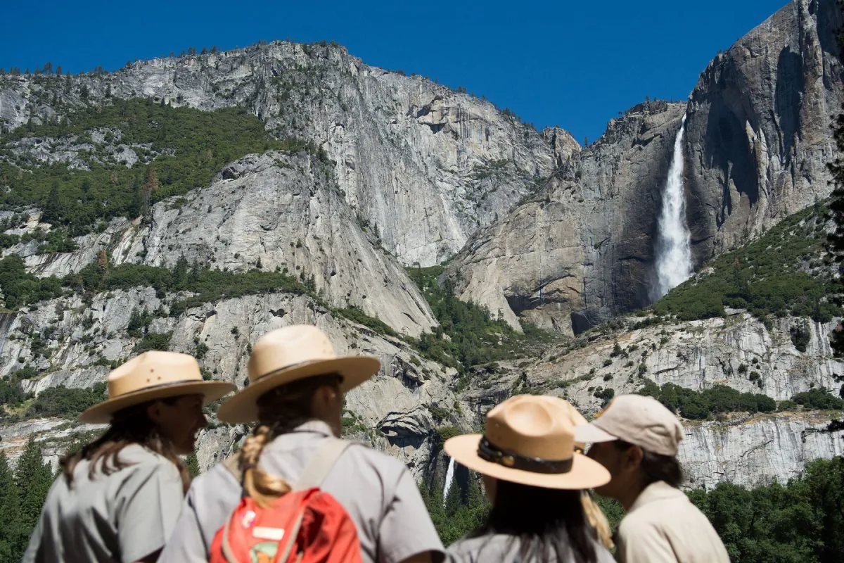 Park rangers meet in front of Yosemite Falls in Yosemite National Park, Calif. on June 18, 2016. (David Calvert/Getty Images)