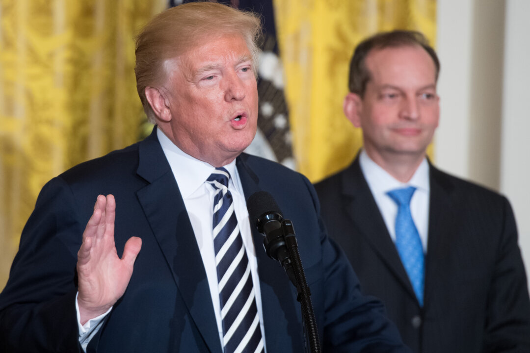 President Donald Trump speaks alongside Secretary of Labor Alexander Acosta (R) during the National Teacher of the Year reception in the East Room of the White House on May 2, 2018. (Saul Loeb/AFP/Getty Images)