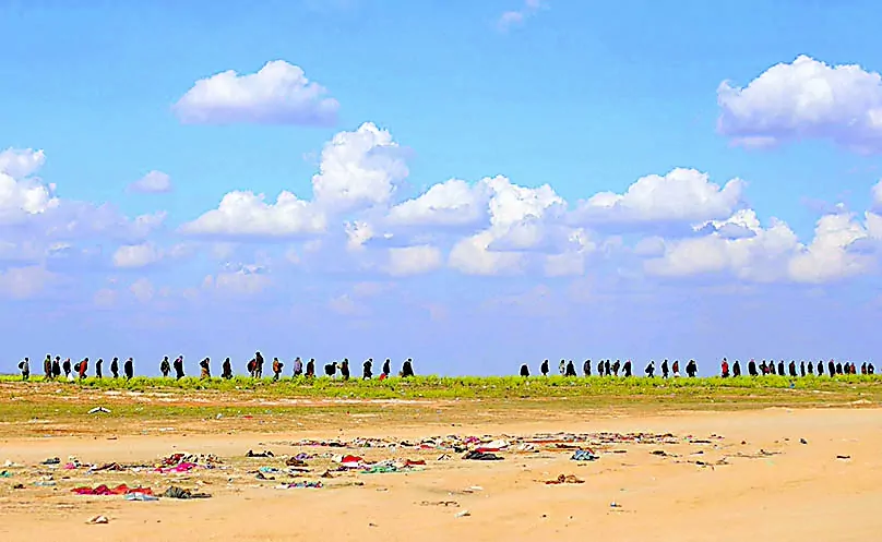 Civilians walk together near Baghouz, Deir Al Zor province, Syria March 6, 2019. REUTERS/Rodi Said