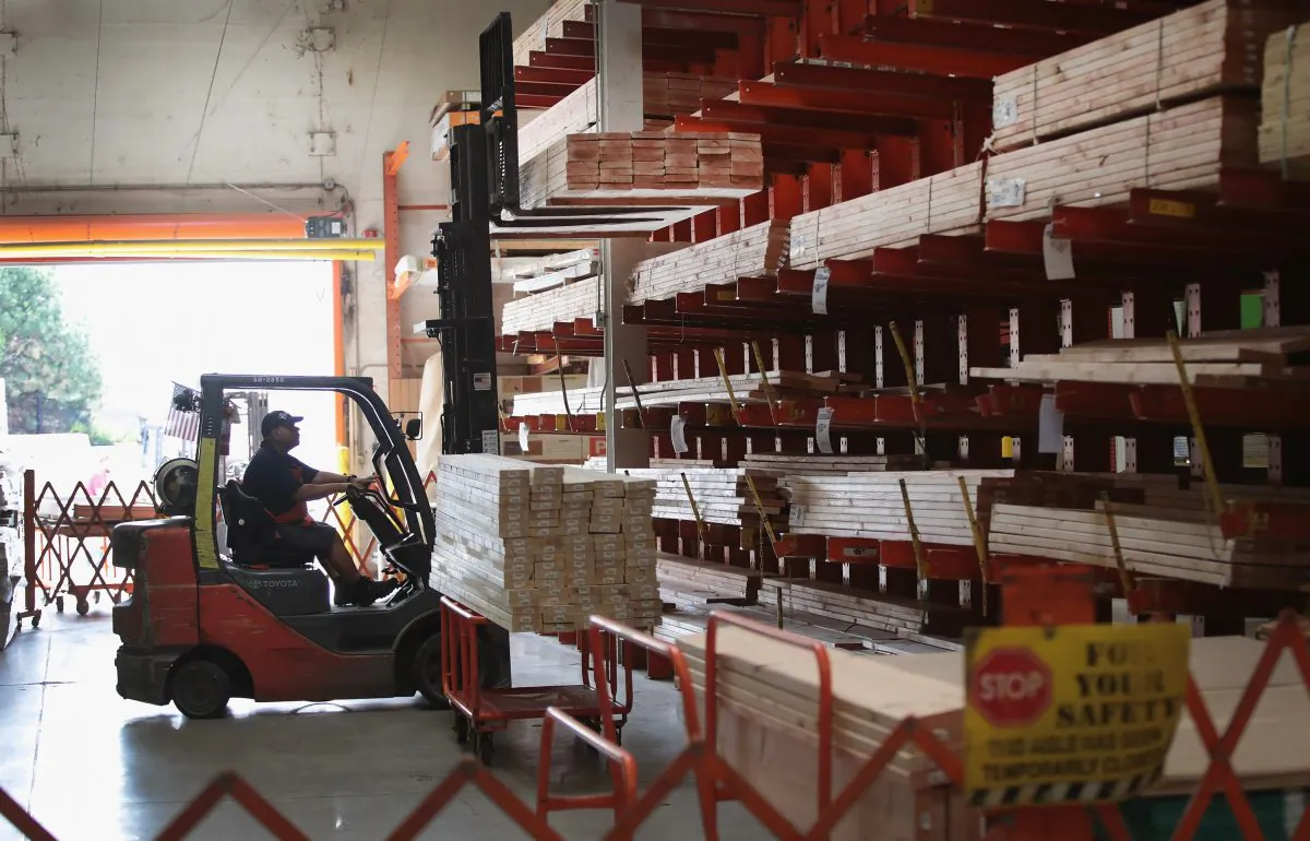 A worker helps a customer with construction supplies at a Home Depot store in Chicago, Ill., on July 26, 2017. (Scott Olson/Getty Images)