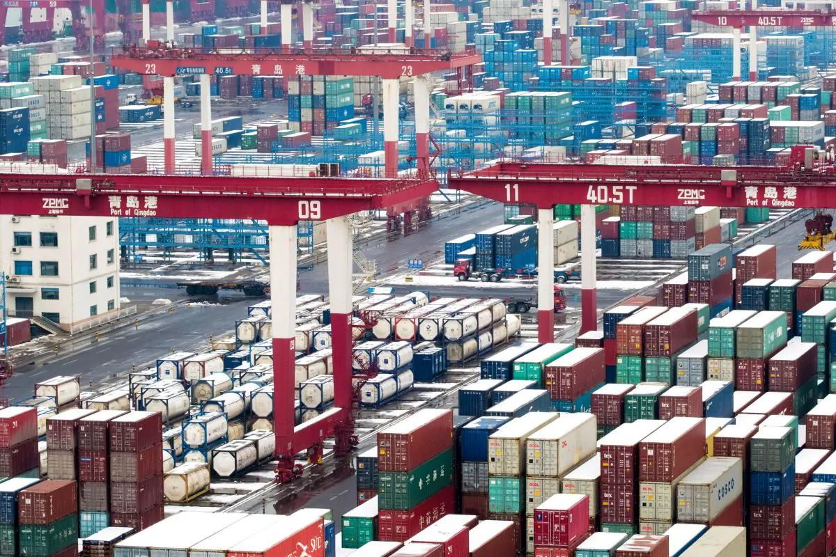 Containers and trucks are seen following a snowfall at the port of Qingdao, Shandong Province, China on Feb. 14, 2019. (Reuters)